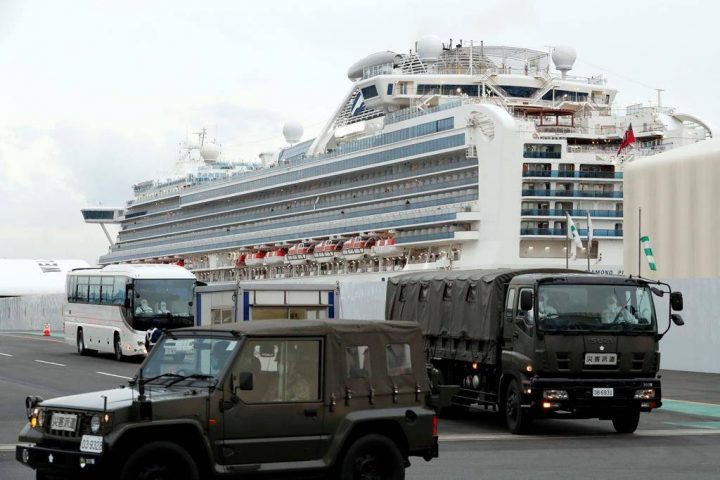 A bus carrying the passengers from the quarantined Diamond Princess cruise ship escorted by Japan Self Defense Forces vehicles leaving a port in Yokohama, near Tokyo, Thursday, Feb. 20, 2020.