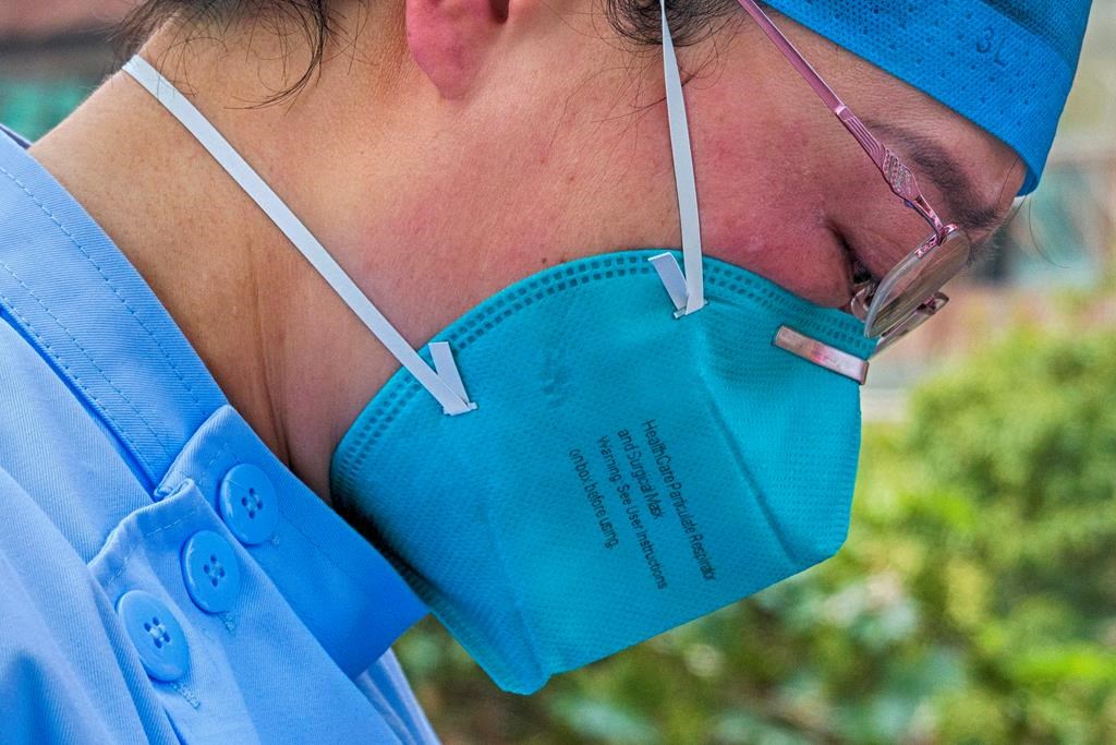 In this Saturday, Feb. 22, 2020, photo released by Xinhua News Agency, a doctor sheds tears after a video call with her son at a hospital in Wuhan in central China’s Hubei Province. (Cai Yang/Xinhua via AP)