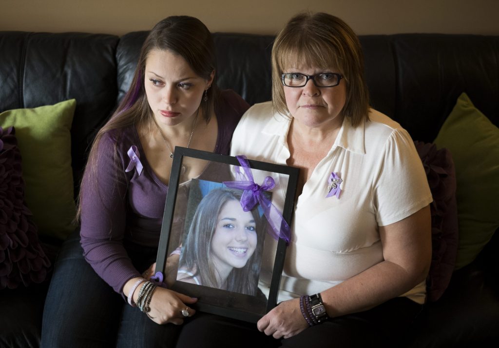 Julie Raymond and her daughter Danielle at their home in Maple Ridge on February 26, 2013 hold a photo of Shannon who died after taking ecstasy on a B.C. party bus in 2008.