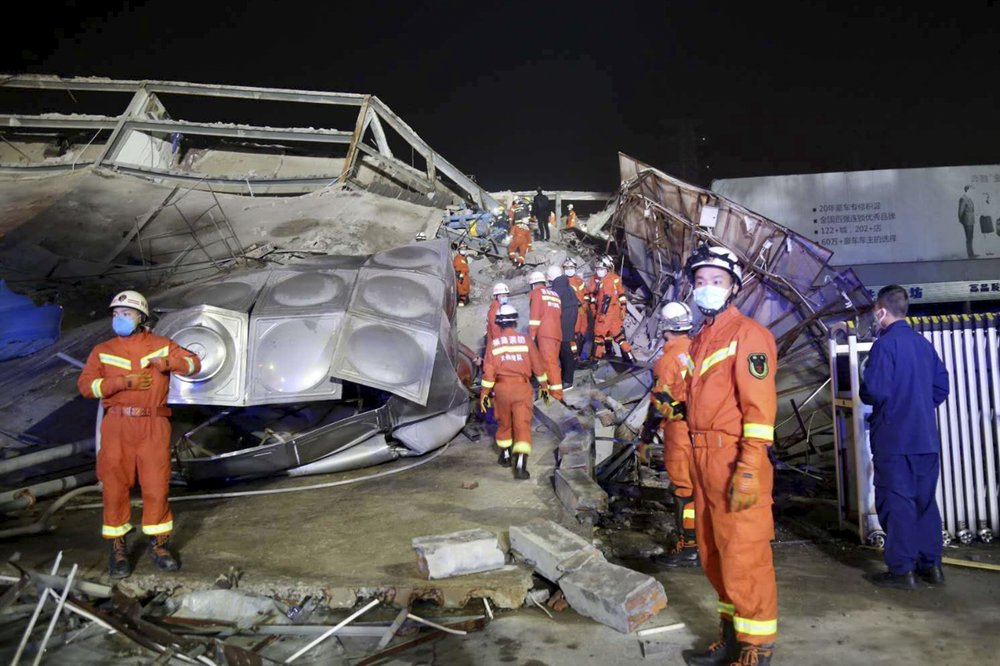 Rescuers work at the site of a collapsed five-story hotel building in Quanzhou city in southeast China's Fujian province Saturday, March 7, 2020. The hotel used for medical observation of people who had contact with coronavirus patients collapsed in southeastern China on Saturday, trapping dozens, state media reported. 
