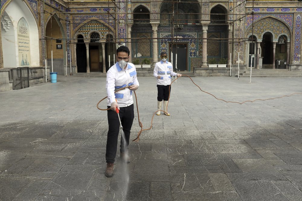 Workers disinfect the shrine of the Shiite Saint Imam Abdulazim to help prevent the spread of the new coronavirus in Shahr-e-Ray, south of Tehran, Iran, Saturday, March, 7, 2020. 
