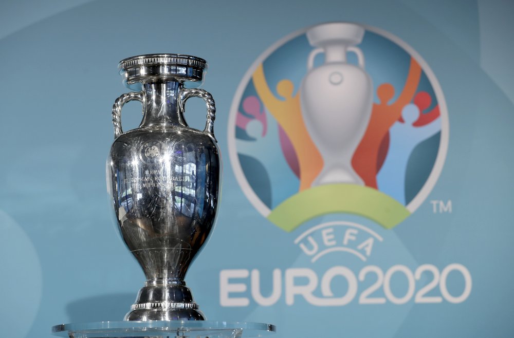 FILE - In this Thursday, Oct. 27, 2016 file photo the Euro soccer championships trophy is seen in front of the logo during the presentation of Munich's logo as one of the host cities of the Euro 2020 European soccer championships in Munich, Germany. UEFA, are set to make a final decision when the UEFA executive committee meets on Tuesday March 17, 2020 after talks with clubs and leagues, about possibly delaying the Euro 2020 soccer tournament by a year as the continent grapples with the outbreak of the coronavirus. 