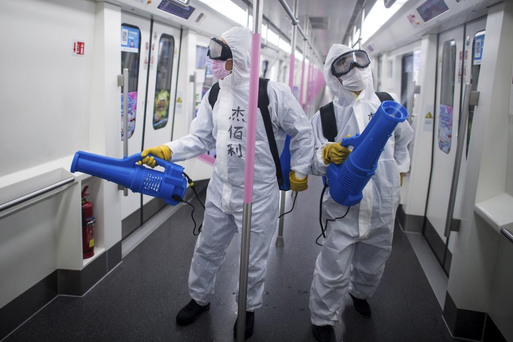 In this March 23, 2020 photo released by Xinhua News Agency, workers disinfect a subway train in preparation for the restoration of public transport in Wuhan, in central China's Hubei province. China's health ministry says Wuhan has now gone several consecutive days without a new infection, showing the effectiveness of draconian travel restrictions that are slowly being relaxed around the country. 
