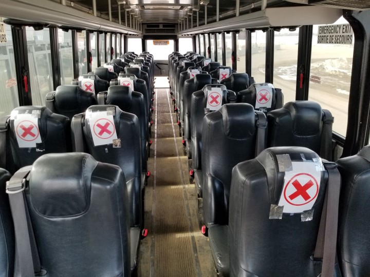 Seats blocked off on the BHP coach between Saskatoon and the Jansen potash project site. Only one person may sit in the clear rows, according to BHP.