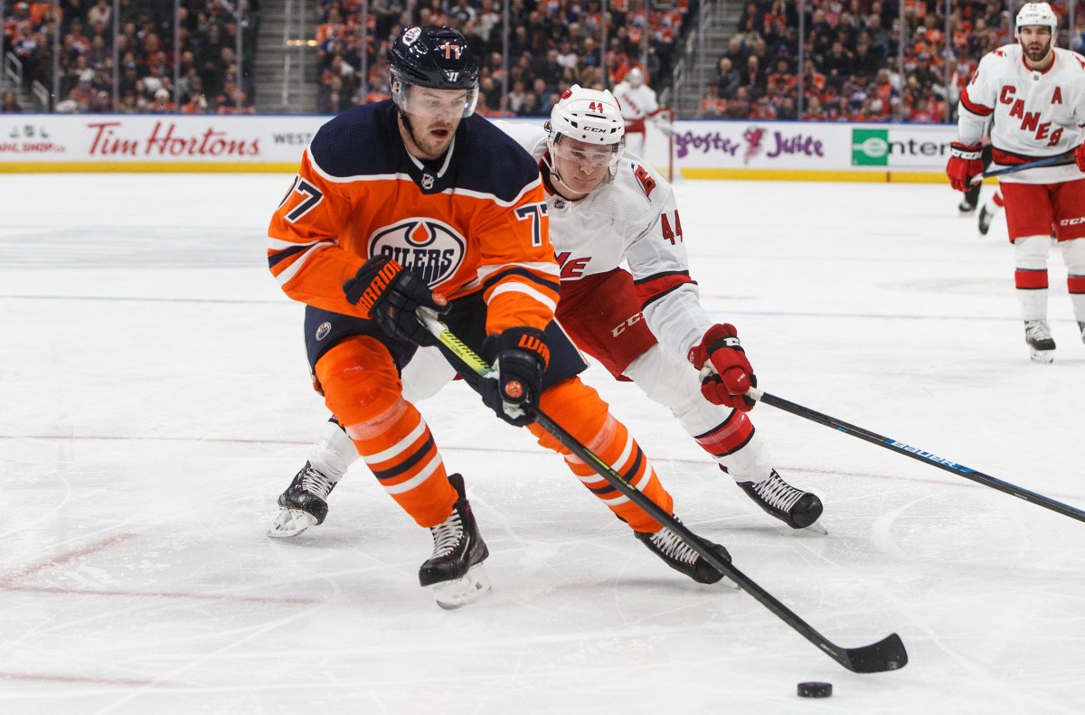Carolina Hurricanes' Julien Gauthier chases Edmonton Oilers' Oscar Klefbom (77) during first period NHL action in Edmonton, Alta., on Tuesday December 10, 2019. THE CANADIAN PRESS/Jason Franson.