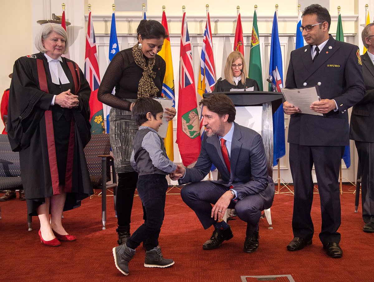 Prime Minister Justin Trudeau greets a young boy as he attends a citizenship ceremony at Acadia University in Wolfville, N.S. on Tuesday, March 3, 2020. 