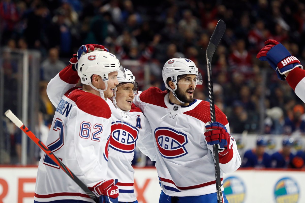 Montreal Canadiens right wing Brendan Gallagher, center, celebrates with left wing Artturi Lehkonen (62) and center Phillip Danault after scoring against the New York Islanders during the first period of an NHL hockey game Tuesday, March 3, 2020, in New York. 