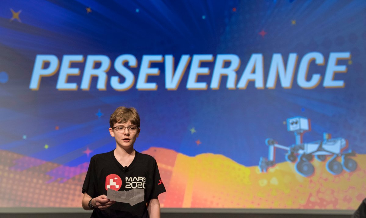 In this image released by NASA, Alex Mather, the student whose submission, Perseverance, was chosen as the official name of the Mars 2020 rover, reads his essay entry, Thursday, March 5, 2020, at Lake Braddock Secondary School in Burke, Va.