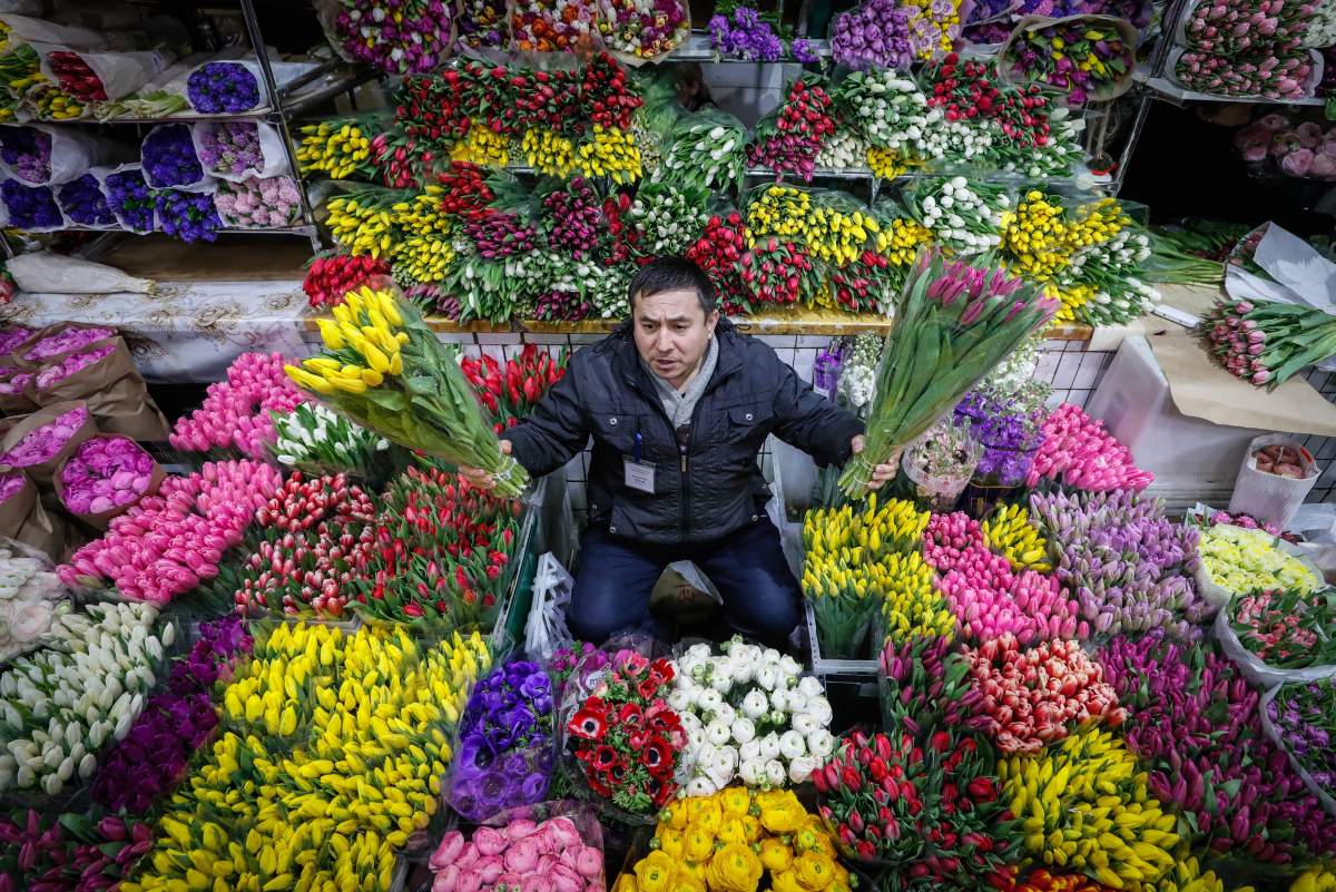 People sell flowers at the flowers market on the eve of the 2019 International Women’s Day in Moscow, Russia. EPA/YURI KOCHETKOV