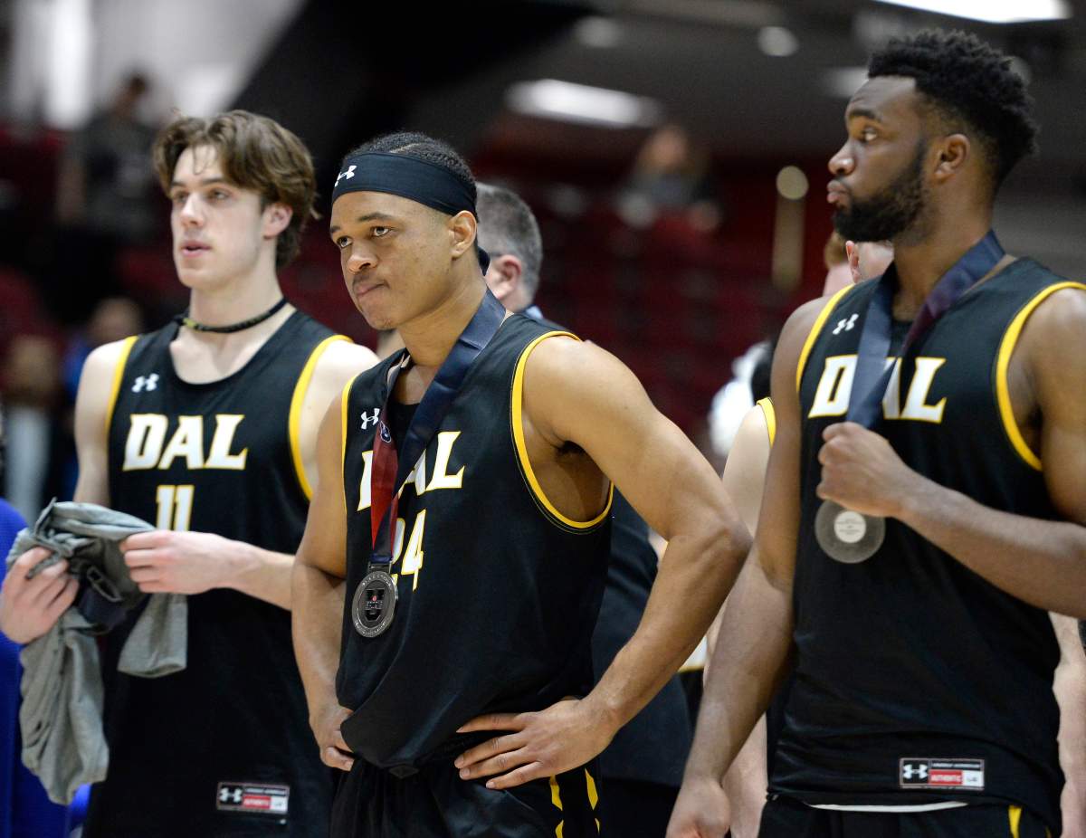 Dalhousie Tigers guard Shamar Burrows (24) stands with teammates after the presentations of their silver medals after losing to the Carleton Ravens in the men’s championship final basketball game of the U Sports Final 8 Championships, in Ottawa, on Sunday, March 8, 2020. THE CANADIAN PRESS/Justin Tang