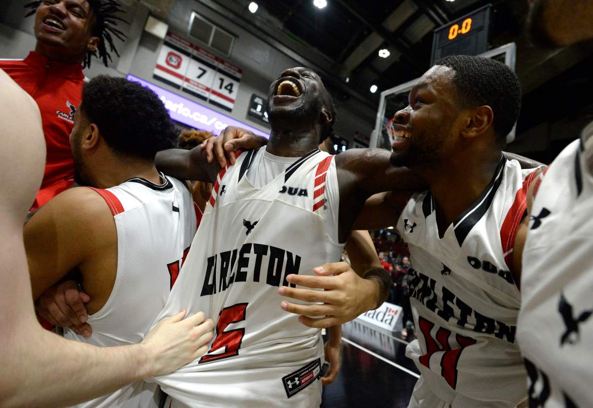 Carleton University Ravens guard Munis Tutu (5) celebrates with forward Lloyd Pandi (41) celebrate their team's win over the Dalhousie Tigers in the men's championship final basketball game of the U Sports Final 8 Championships, in Ottawa, on Sunday, March 8, 2020. 