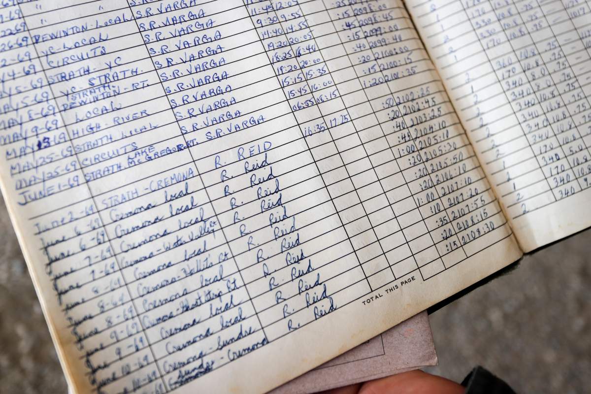 David Reid, a farmer and pilot, looks over the log book of the plane that his father Richard purchased as a 17 year-old and which he is now restoring at their farm near Cremona, Alta., Wednesday, March 4, 2020. The log book shows Reid first flight of 50 minutes from Strahmore, AB, to Cremona, AB, in the airplane on June 2, 1969.