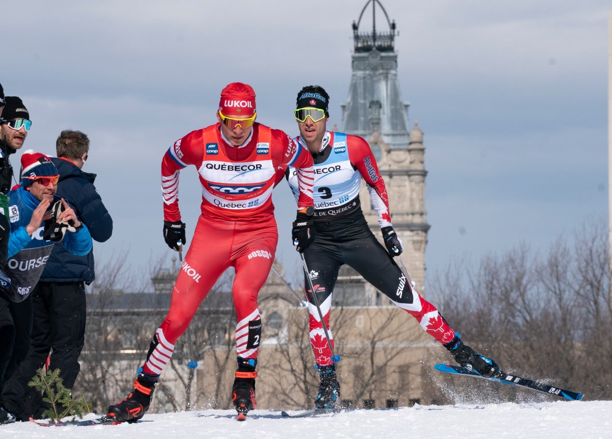 Alexander Bolshunov of Russia, left, and Alex Harvey of St-Ferreol-les-Neiges Que. race during the men's 15 km pursuit free Sunday, March 24, 2019 at the COOP FIS cross country world cup in Quebec City. The World Cup cross-country ski event this weekend in Quebec City has been cancelled because of the COVID-19 outbreak. 