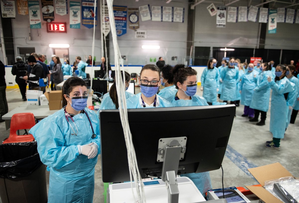 Medical staff work at a computer terminal as they prepare for the opening of the COVID-19 Assessment Centre at Brewer Park Arena in Ottawa, during a media tour on Friday, March 13, 2020. The assessment centre, operated by The Ottawa Hospital and CHEO, is an out-of-hospital clinic where people can be assessed and tested for COVID-19 if required.