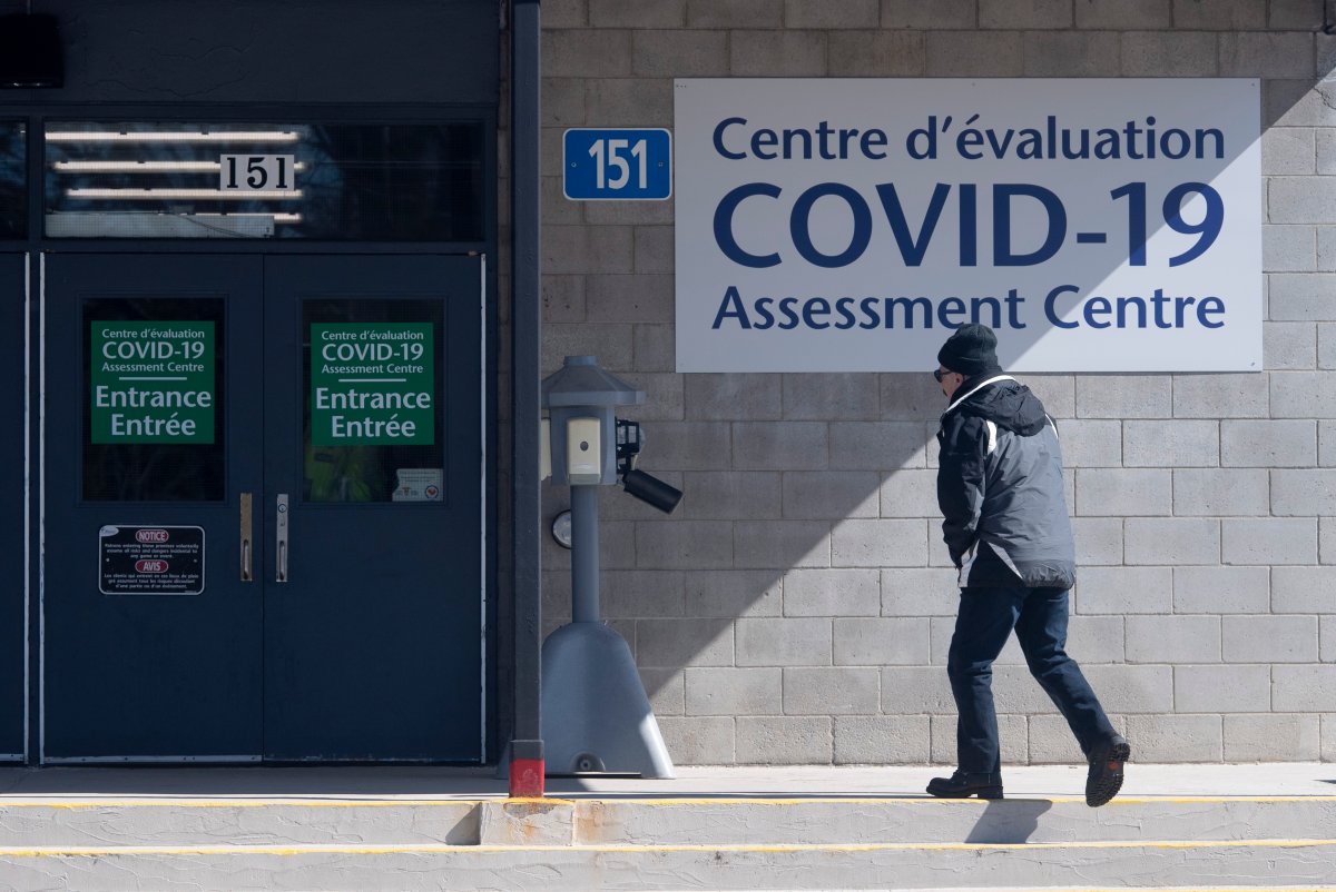 A man makes his way to a COVID-19 assessment centre setup at a city building Saturday, March 14, 2020 in Ottawa. THE CANADIAN PRESS/Adrian Wyld.