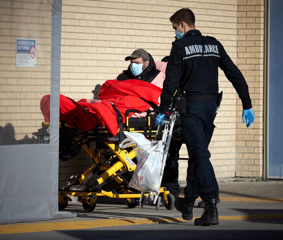 A paramedic brings a patient to Notre-Dame hospital in Montreal, Canada, 15 March 2020. 