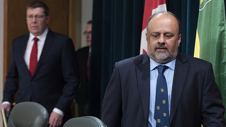 Saqib Shahab, chief medical health officer, and Scott Moe, premier of Saskatchewan, from right, arrive to a COVID-19 news update at the legislative building in Regina on Wednesday March 18, 2020.