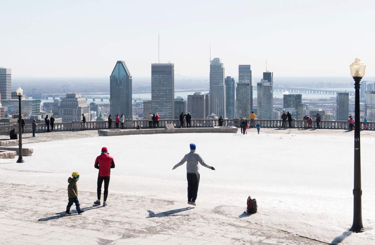 People gather at the Mount Royal lookout in Montreal, Saturday, March 21, 2020, as COVID-19 cases rise in Canada and around the world.