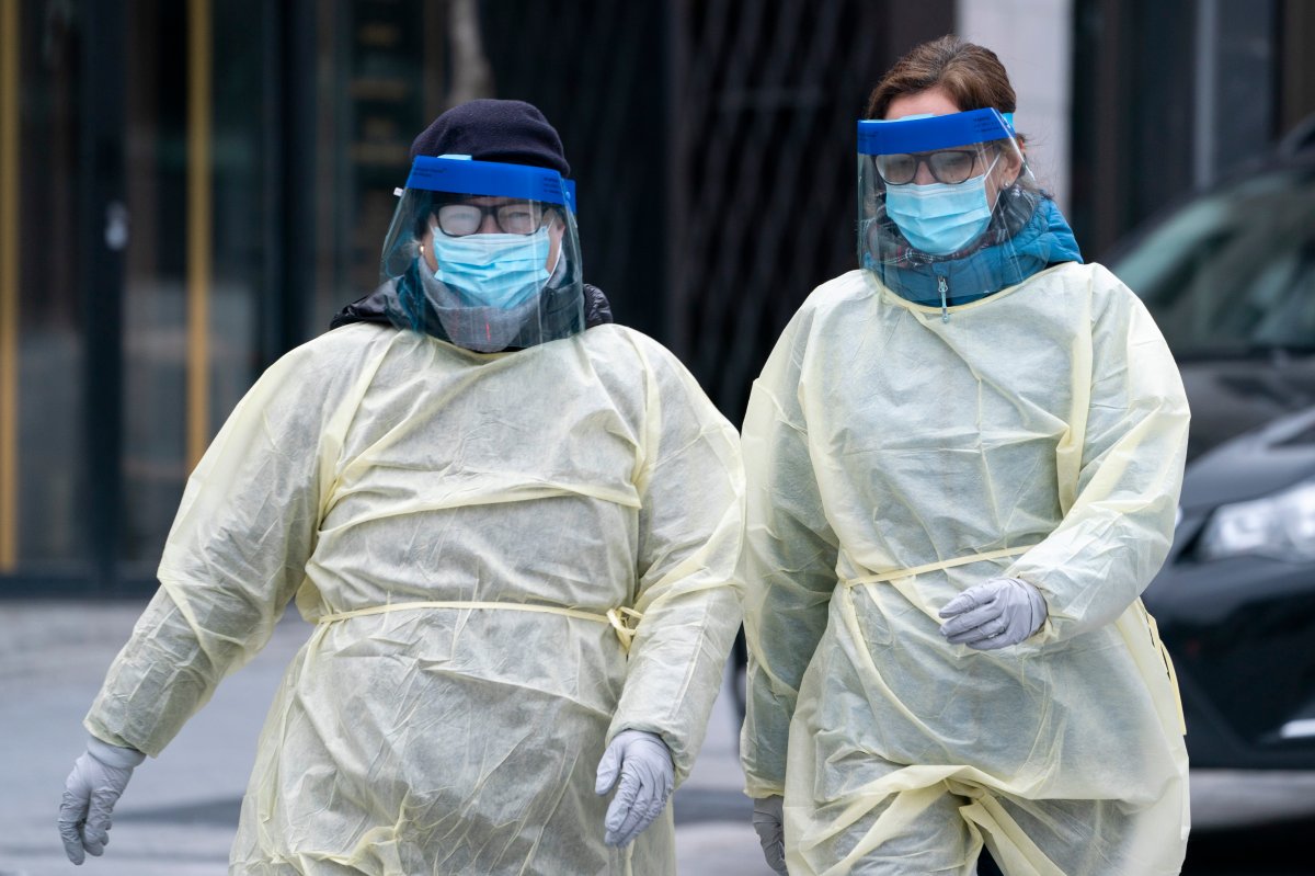 Two health care workers arrive at a walk-in COVID-19 test clinic in Montreal on Monday, March 23, 2020. 