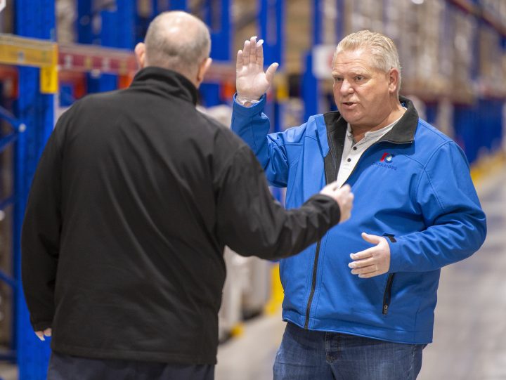 Ontario Premier Doug Ford talks with Metro Supply Chain Group COO Murray Brabender while inspecting personal protective equipment supplies at a warehouse in Toronto on Sunday, March 29, 2020. 