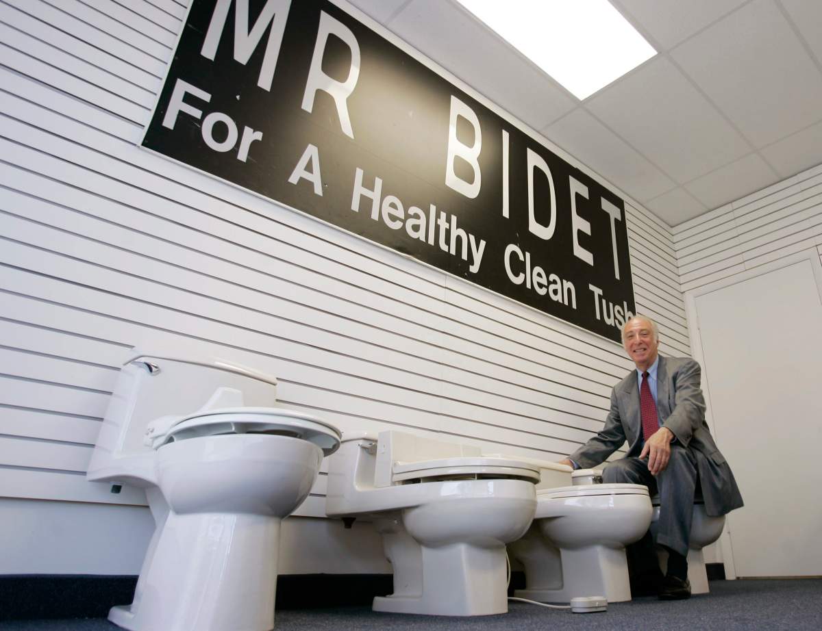 Arnold Cohen poses for a photo with his line of bidets, starting on the left with the original model Aug. 26, 2007 at his Weston, Fla., showroom/warehouse. Cohen held the patent on for the “American Bidet” since the early 1960s.