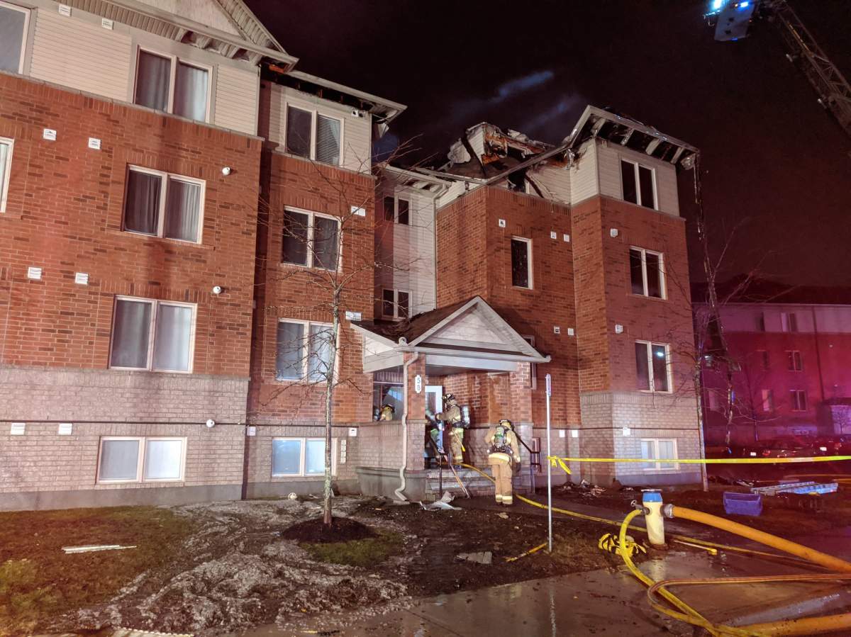 Ottawa firefighters battle a blaze that broke out in a row home complex on Barnstone Drive in Barrhaven on March 31, 2020.