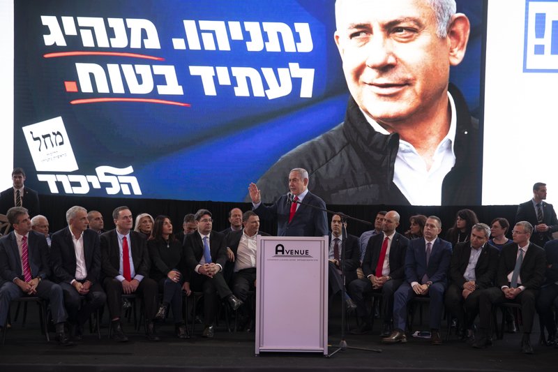 Israeli Prime Minister Benjamin Netanyahu, center, speaks during a Likud faction meeting in Tel Aviv, Israel, Sunday, March 1, 2020. 