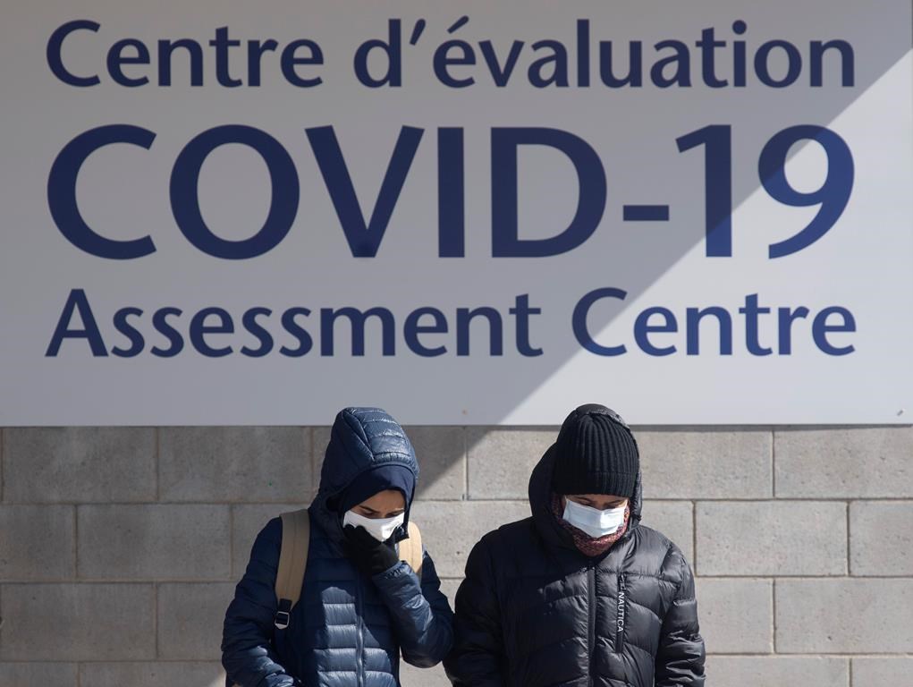 People leave a COVID-19 assessment centre Saturday, March 14, 2020 in Ottawa. THE CANADIAN PRESS/Adrian Wyld.