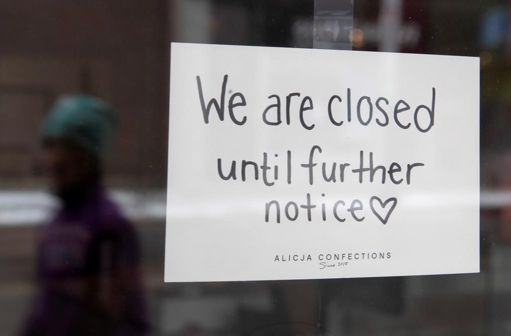 A sign on a shop window indicates the store is closed in Ottawa, Monday March 23, 2020. . THE CANADIAN PRESS/Adrian Wyld.
