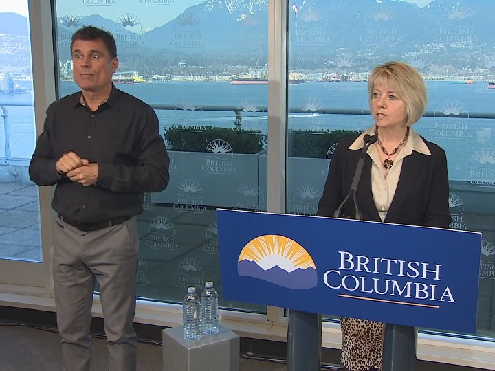 Provincial health officer Dr. Bonnie Henry, right, looks on during a coronavirus media gathering on Thursday.