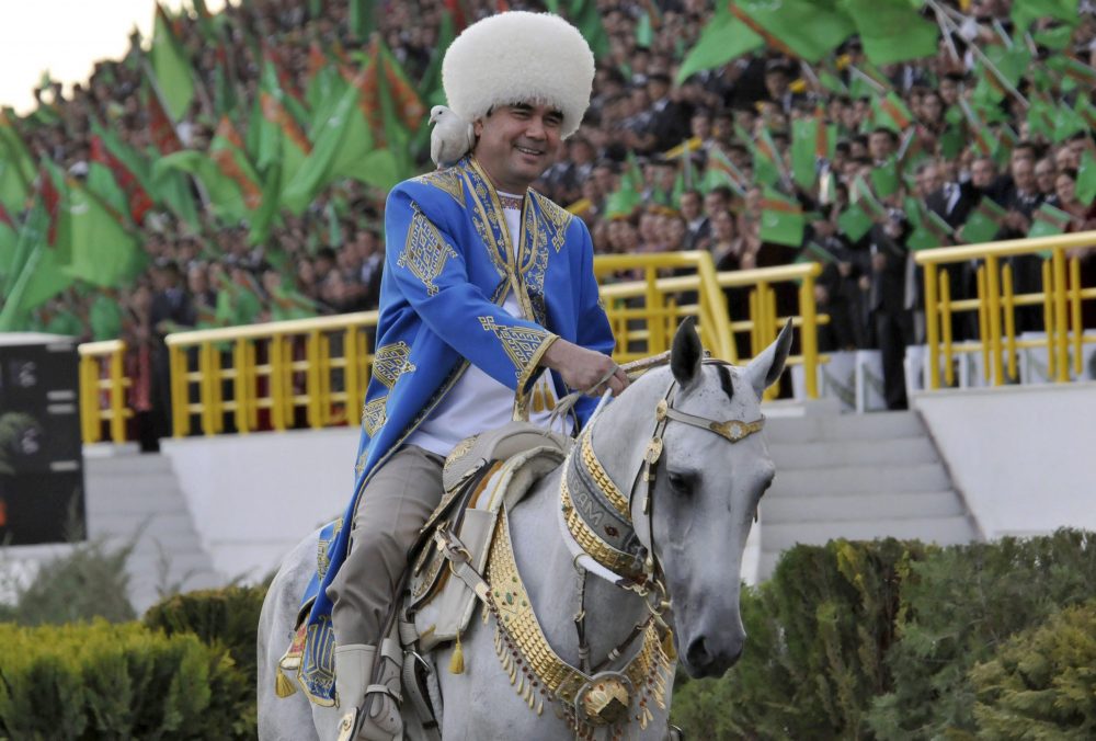 In this April 23, 2011 file photo, Turkmenistan’s President Gurbanguly Berdymukhamedov smiles as he rides a horse with a dove on his shoulder at a ceremony in the capital Ashgabat, Turkmenistan.