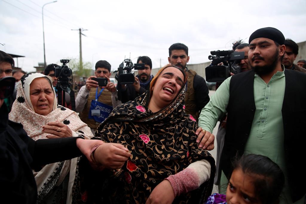 Family members cry after an attack in Kabul, Afghanistan, Wednesday, March 25, 2020. Gunmen stormed a religious gathering of Afghanistan's minority Sikhs in their place of worship in the heart of the Afghan capital's old city on Wednesday, a minority Sikh parliamentarian said.
