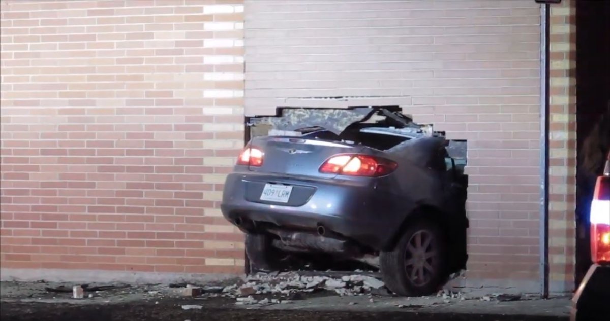 Police say the car broke through a brick wall and came to a stop inside the building, say police.