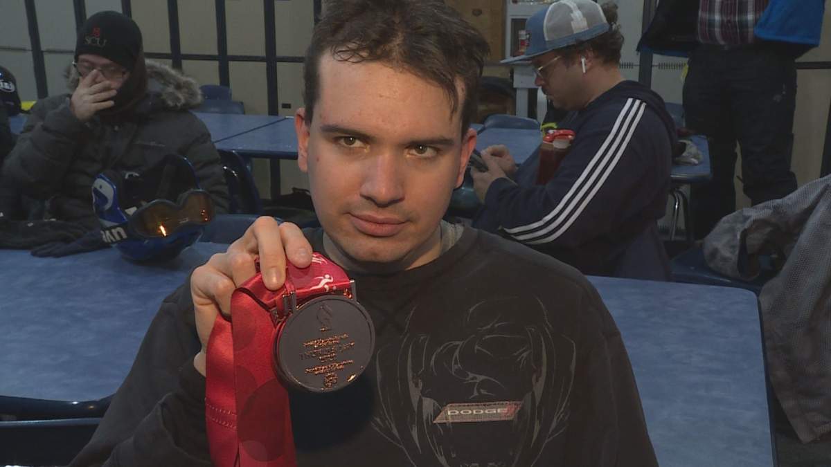 Michael Milani showing off one of his three bronze medals from the Canadian Special Olympics in Thunder Bay.