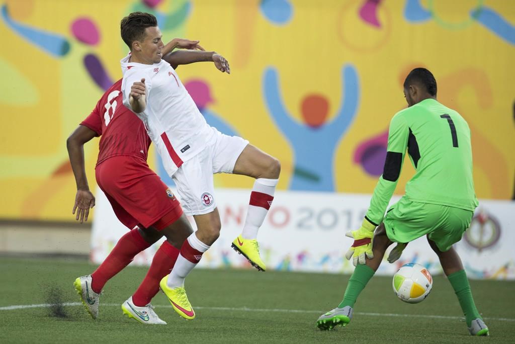 Canada's Ben Fisk (7) tries to get the ball past Panama keeper Jaime de Gracia (1) while being chased by Panama's Fidel Escobar (6) during 2015 Pan Am Games first half men's soccer action in Hamilton, Ont. on Thursday, July 16, 2015. Atletico Ottawa has made Canadian international winger Ben Fisk its first signing.