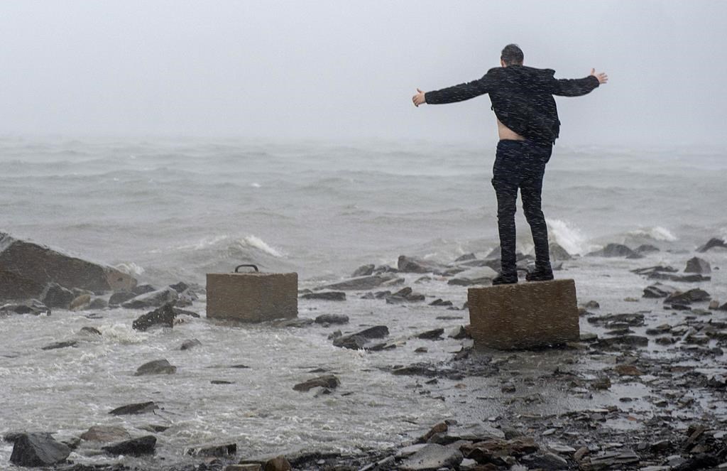 An unidentified man watches the impact of hurricane Dorian along the Halifax harbour in Dartmouth, Nova Scotia, Canada, on Saturday, September 7, 2019.