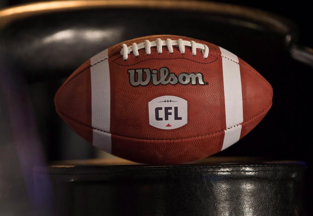 A football with the new CFL logo sits on a chair in Winnipeg on November 27, 2015. The CFL announced Wednesday it's going ahead with its regional combines as well as its national combine in Toronto as worries over the spread of COVID-19 caused the cancellation of sporting events across the globe, including the world figure skating championships in Montreal. THE CANADIAN PRESS/John Woods.