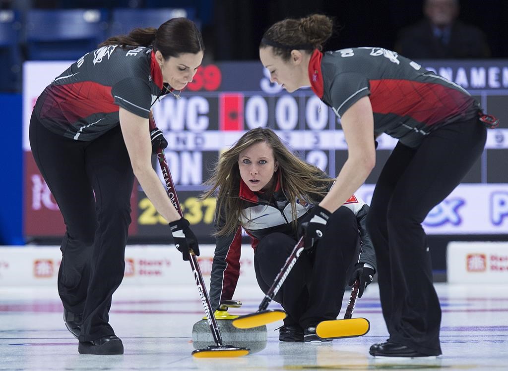 Ontario skip Rachel Homan delivers a rock as lead Lisa Weagle, left, and second Joanne Courtney sweep in championship pool action against the Wild Card team at the Scotties Tournament of Hearts at Centre 200 in Sydney, N.S. on Thursday, Feb. 21, 2019. Weagle was shocked to receive word this week that Team Homan would no longer be needing her services. THE CANADIAN PRESS/Andrew Vaughan.