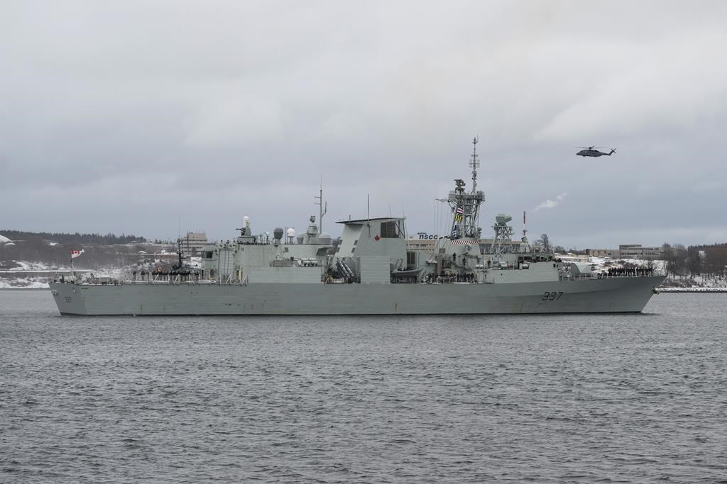 A Cyclone helicopter flies over HMCS Fredericton as its crew leaves the Halifax Harbour for a six-month deployment to the Mediterranean Sea as part of NATO's Operation Reassurance in Halifax on January 20, 2020. THE CANADIAN PRESS/Darren Calabrese.