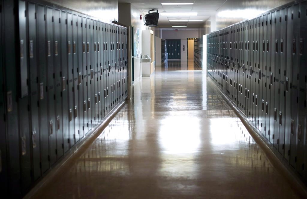 An empty hallway is seen at a school.