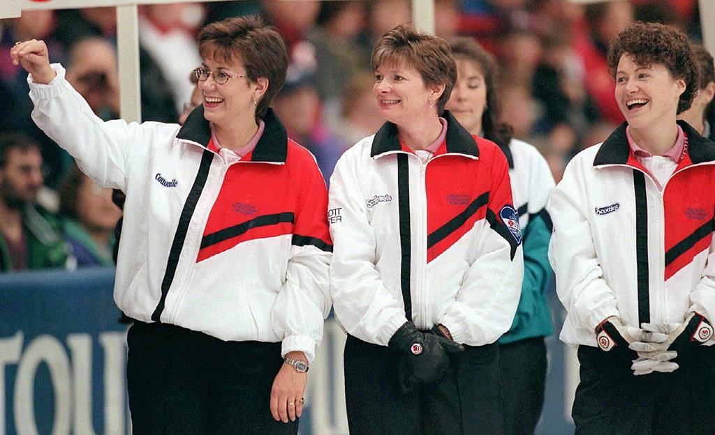 Team Canada skip Sandra Schmirler waves to family in the crowd as third Jan Betker centre and second Joan McCusker, right, look on prior to the first draw of the Canadian women's curling championships in Regina, Saturday, Feb.22, 1998. Schmirler died 20 years ago Monday from cancer at age 36. Her legacy encompasses a gold standard every Canadian women's team strives to match in competition. THE CANADIAN PRESS/Chuck Stoody.