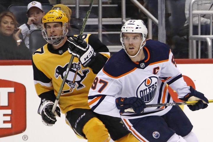 In this Nov. 2, 2019, file photo, Edmonton Oilers' Connor McDavid (97) and Pittsburgh Penguins' Sidney Crosby (87) skate during the second period of an NHL hockey game in Pittsburgh. 