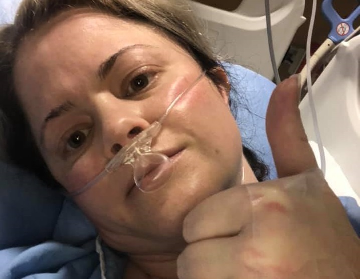 COVID-19 patient Erin Leigh gives the thumbs up from a hospital bed in the Calgary area. 