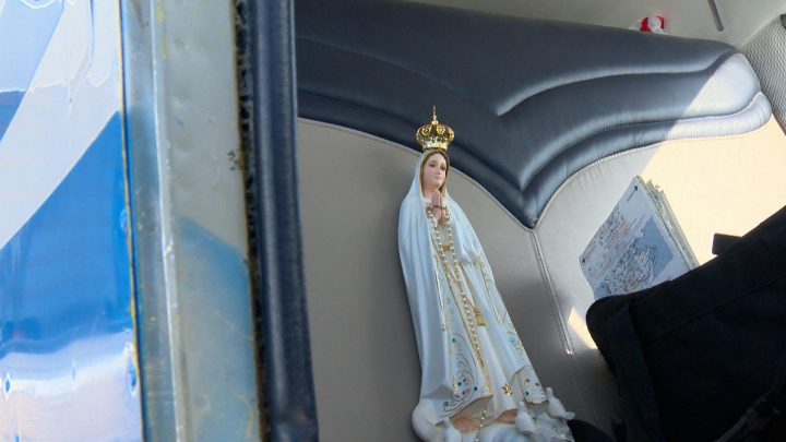 An Our Lady of Fátima statue buckles in before take-off.