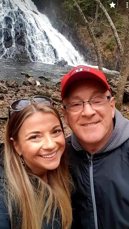 Kelly Marshall, left, and her father Rick Cameron pose for a selfie at a waterfall in Nova Scotia in an undated handout photo. The daughter of a Nova Scotia man relying on a ventilator for breath wants Canadians to recall COVID-19 can deny loved ones the ability to hold one another in their time of deepest need.