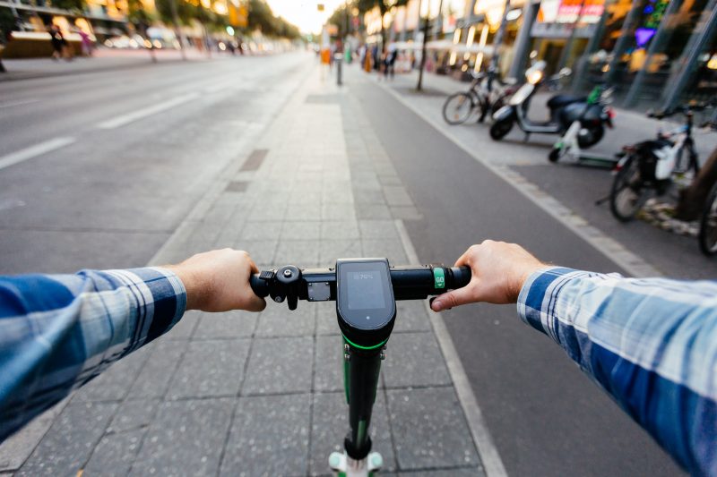 File: The point of view of someone riding an electric scooter.