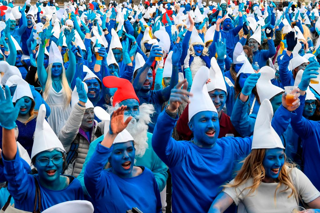 People dressed as Smurfs (“Schtroumpfs” in French), a Belgian comic franchise centred on a fictional colony of small, blue, human-like creatures who live in mushroom-shaped houses in the forest, attend a world-record gathering of Smurfs on March 7, 2020, in Landerneau, western France.