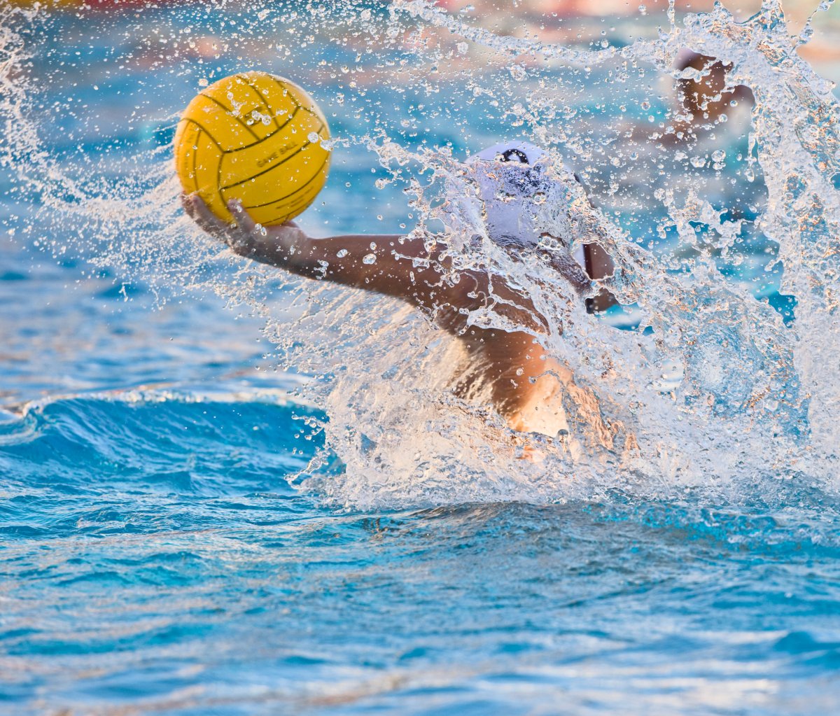 A file photo of a water polo player passing the ball.