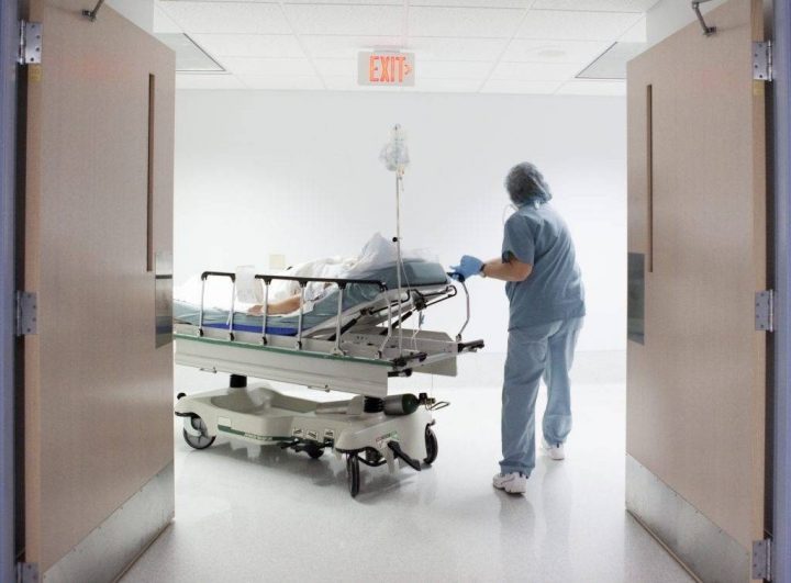 A file photo of a healthcare worker pushing a stretcher.