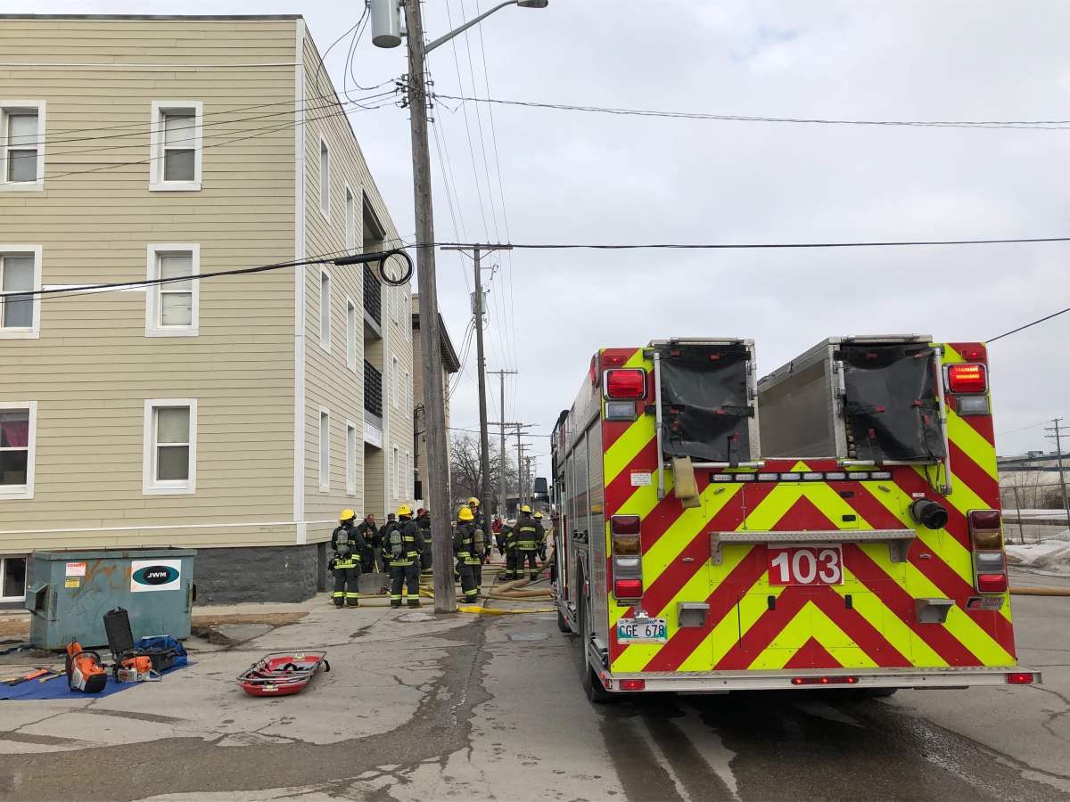 Fire crews at a fire at an apartment building in Point Douglas.